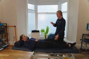 ProSport Physio discussing with knee pain patient.