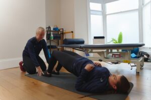 Physiotherapist treating patient with knee pain.