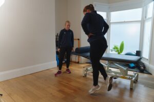 Patient performing single leg hop at ProSport physio clinic with therapist.