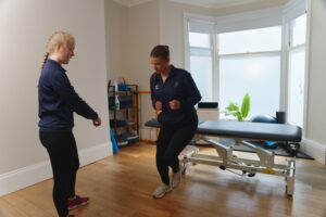Physio with patient doing exercise at ProSport physio in Huddersfield.