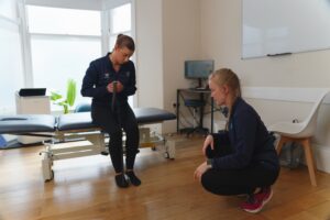 Physiotherapist with achilles pain patient.