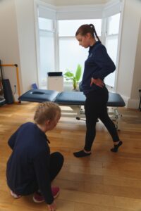 Prosport physio assessing a patient with hip paint.