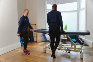 ProSport physiotherapist with achilles pain patient in huddersfield clinic.