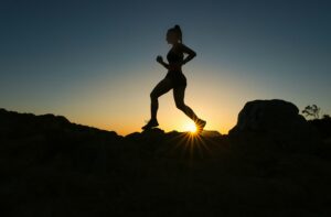 Woman running with hip pain.